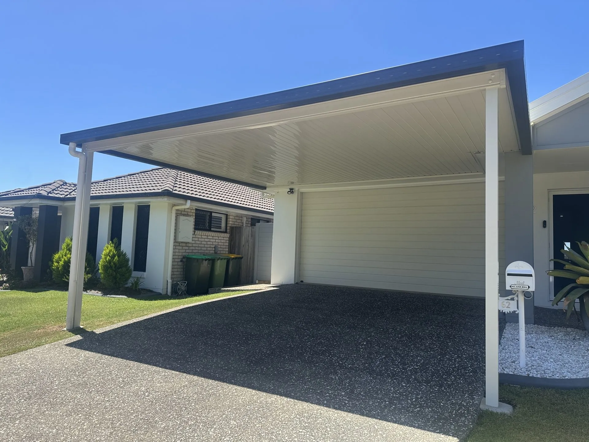 Attached V-Line carport beside a two-storey home
