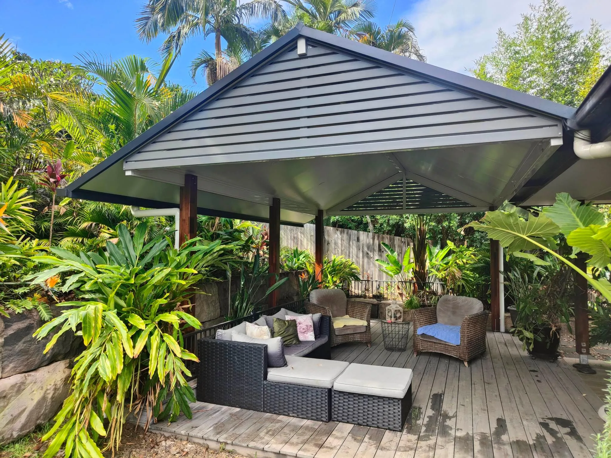 Gable patio over an outdoor lounge in a leafy backyard